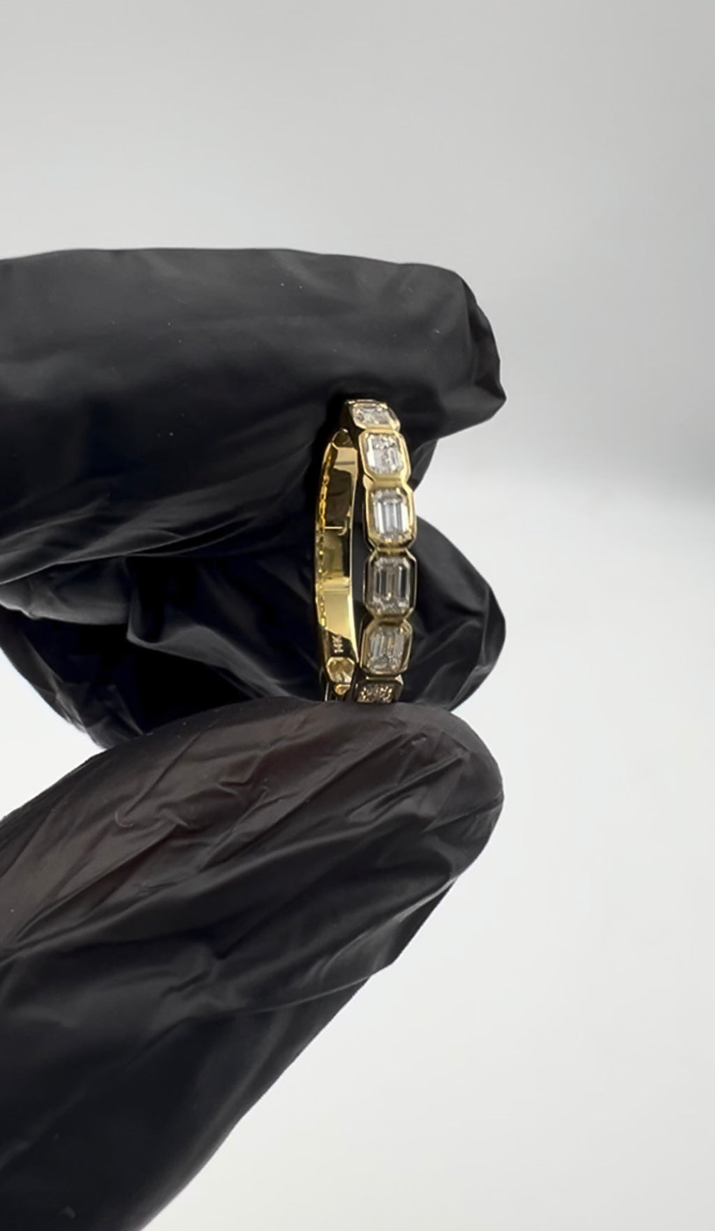 1.00CT EMERALD EAST WEST BEZEL SET 3/4 ETERNITY BAND
